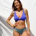Woman wearing ocean blue bikini top and stone blue bottom by Paupa, front view