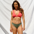 Woman wearing a red bikini top and khaki bottom by Paupa, front view